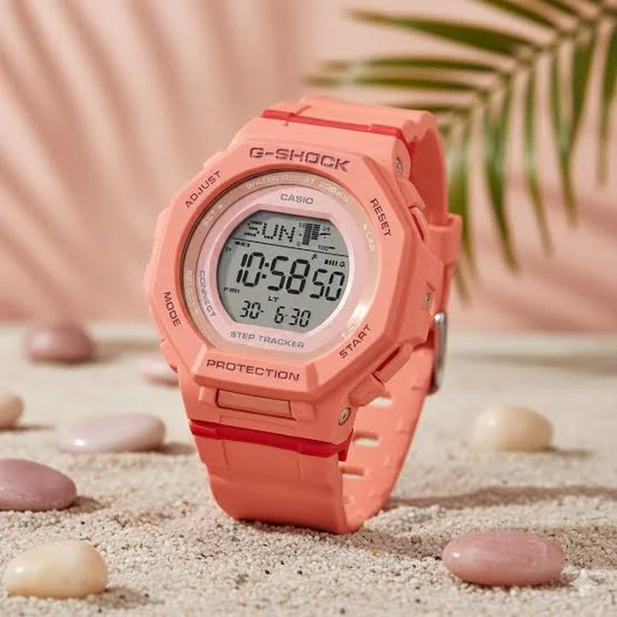 Casio G-Shock G-Squad GMD-B300SC-4DR women’s digital sport watch with a coral-tone case and strap, round digital display, and contrasting red accent details.