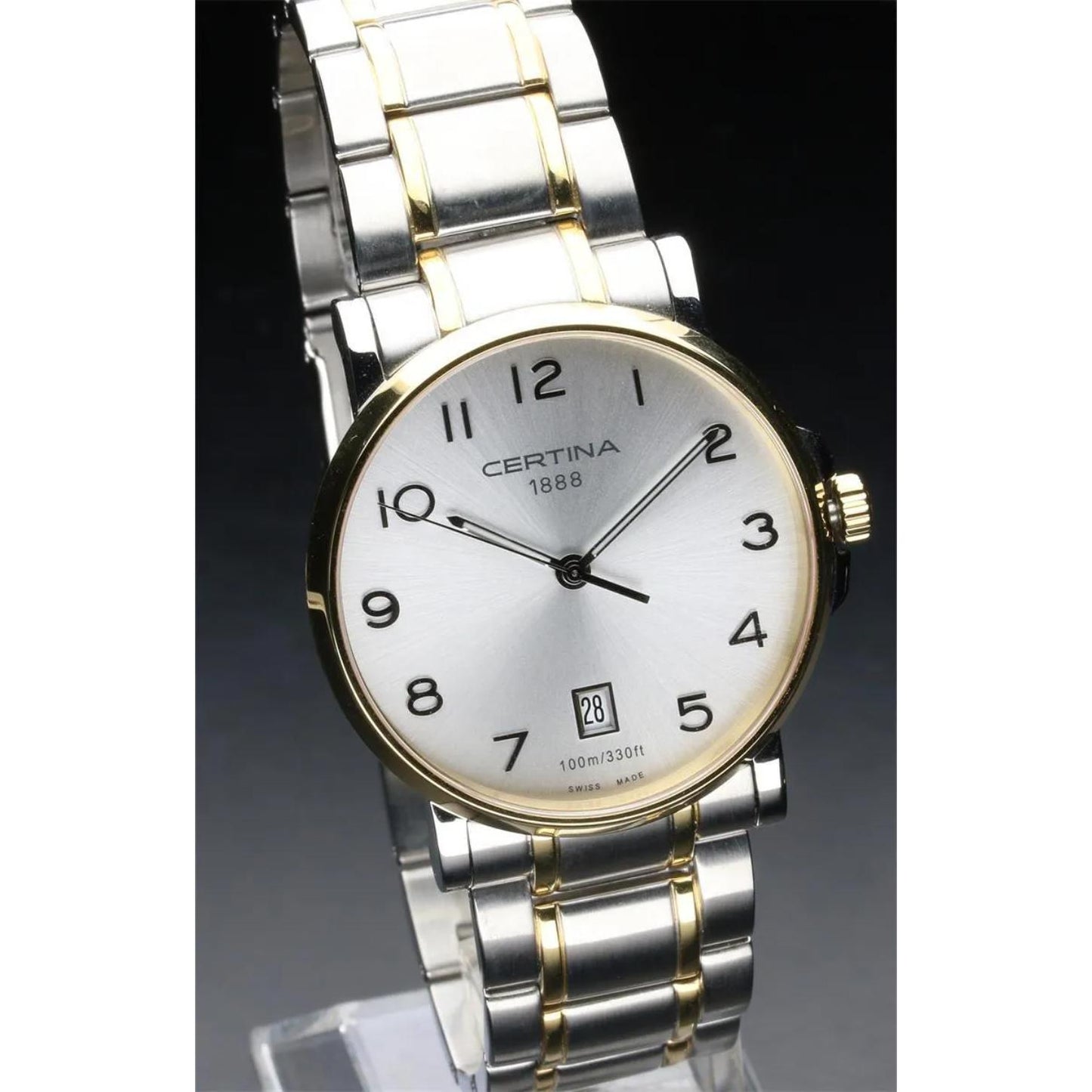 Certina C017.410.22.032.00 mens dress watch with silver dial, gold tone bezel and two tone stainless steel bracelet displayed on stand with classic design