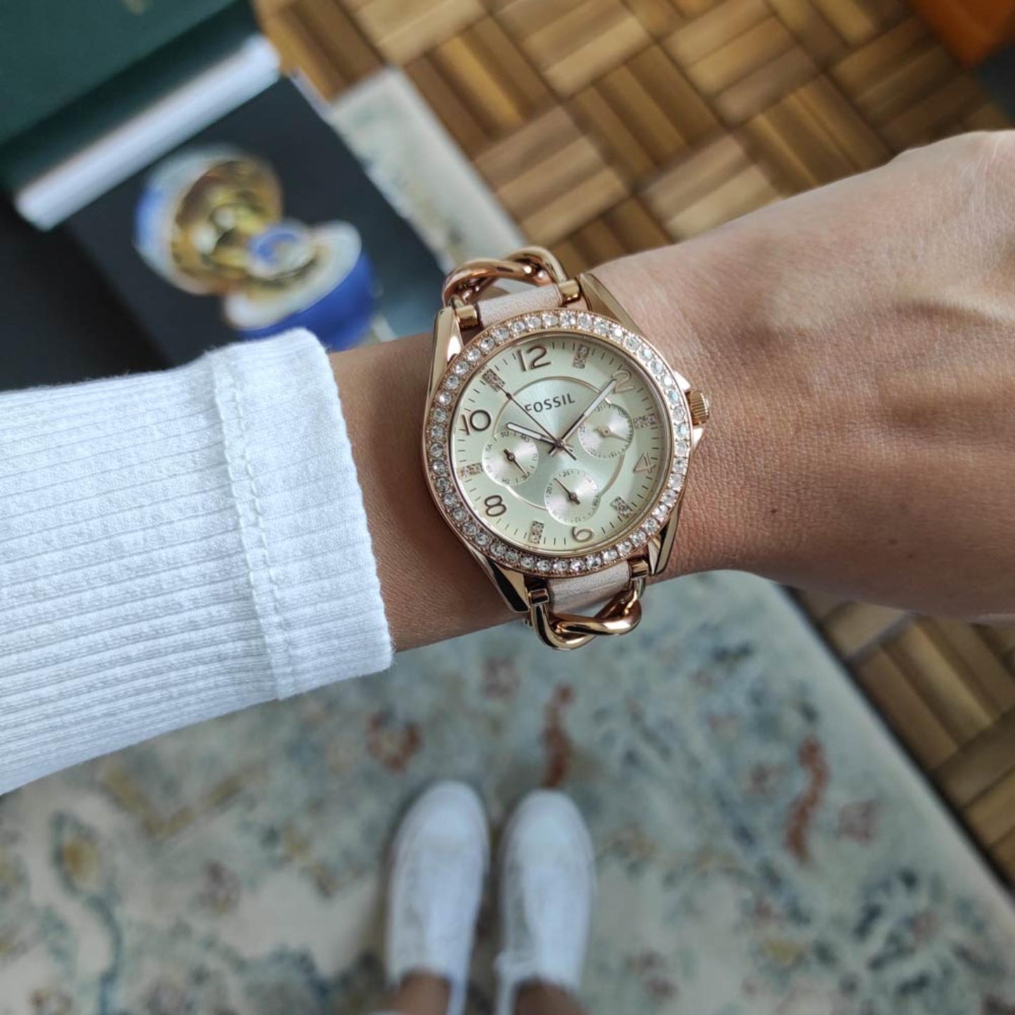 Fossil ES3466 womens watch with rose gold tone case, crystal bezel and beige strap worn on wrist in everyday casual setting