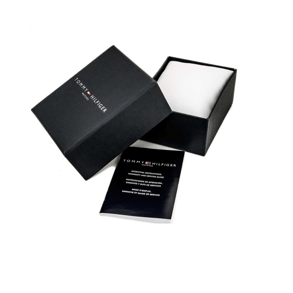 Caja Tommy Hilfiger de reloj abierta con manual de garantía y cojín interior, color negro.