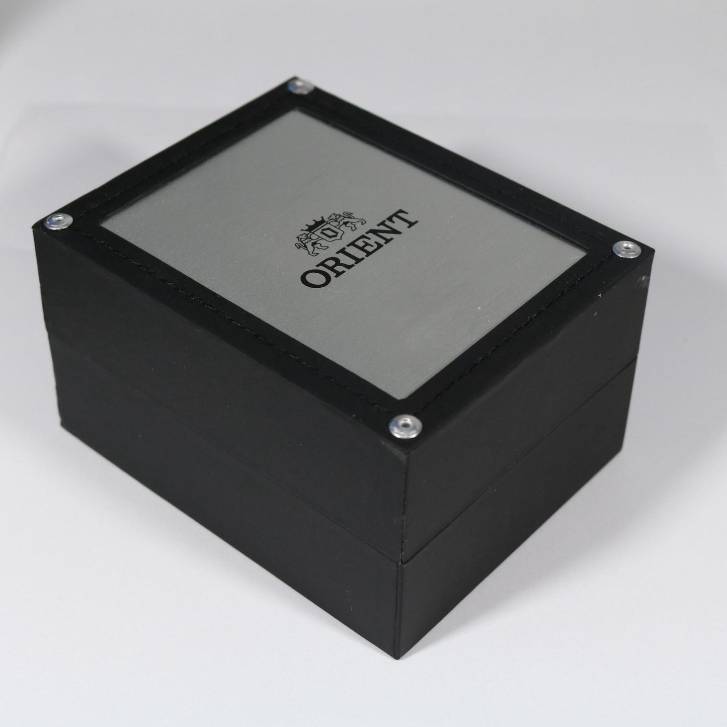 Orient watch presentation box with black wooden exterior, brushed metal lid panel, and Orient logo branding on top.
