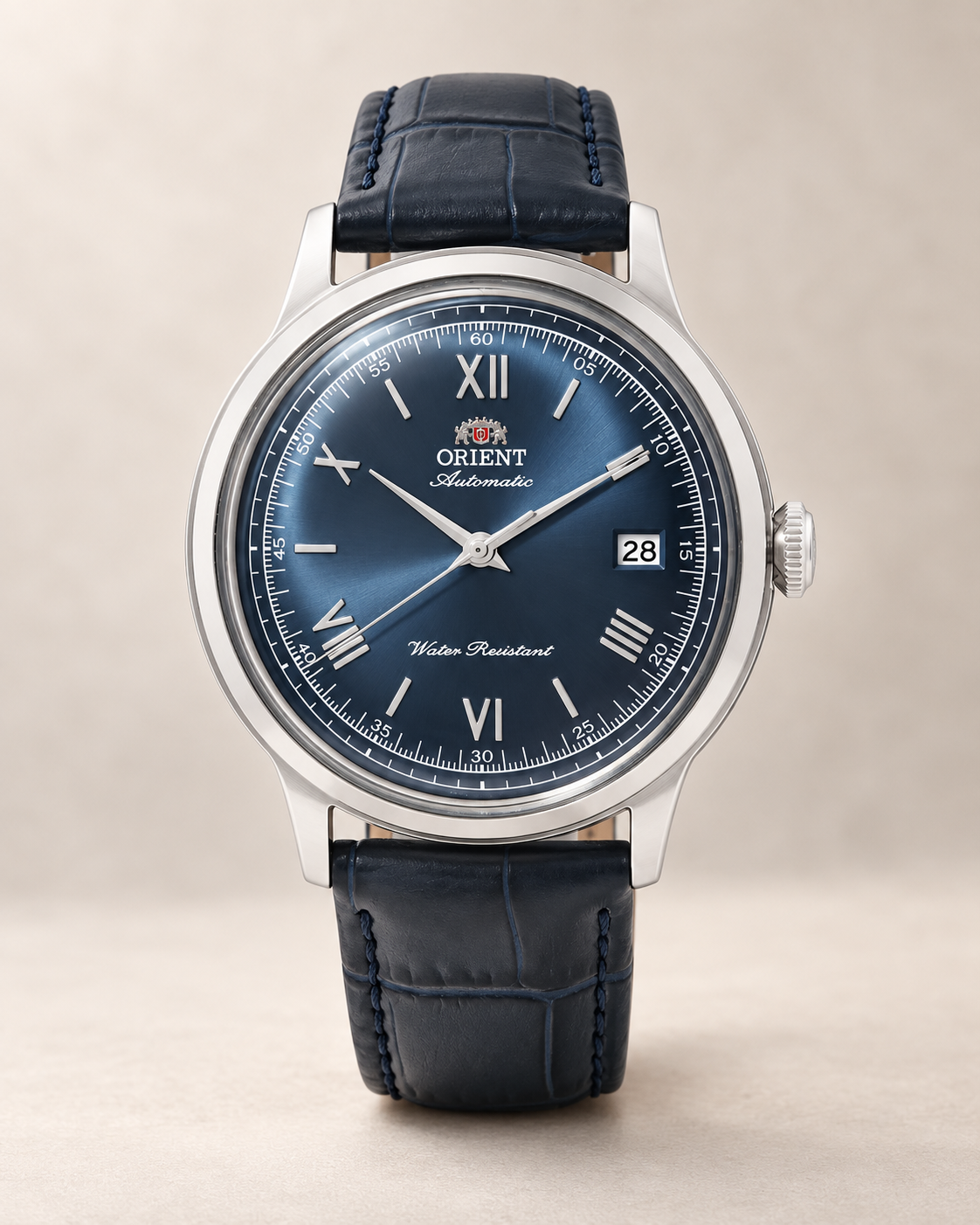 Orient Bambino automatic watch with gray dial worn on a wrist