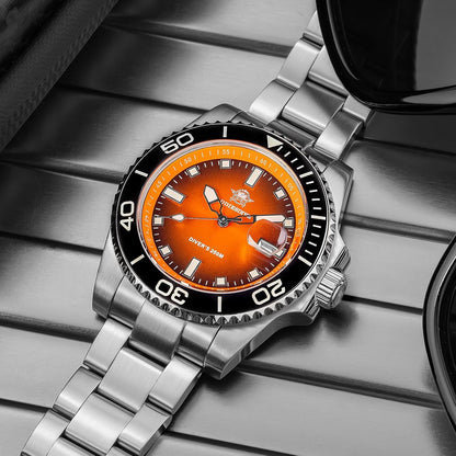 Reloj Addiesdive automático con esfera naranja visto en perspectiva superior, mostrando el brazalete de acero inoxidable y el bisel negro sobre una superficie metálica.
