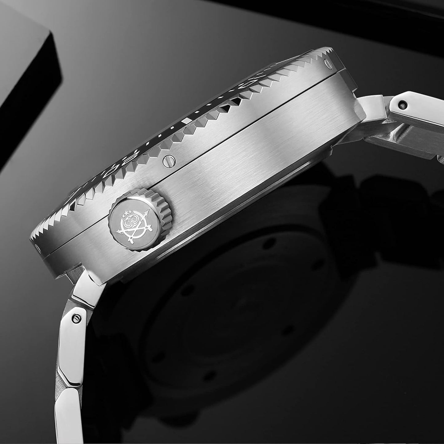 Reloj Addiesdive automático de acero mostrado en vista lateral destacando la corona grabada y el perfil de la caja.