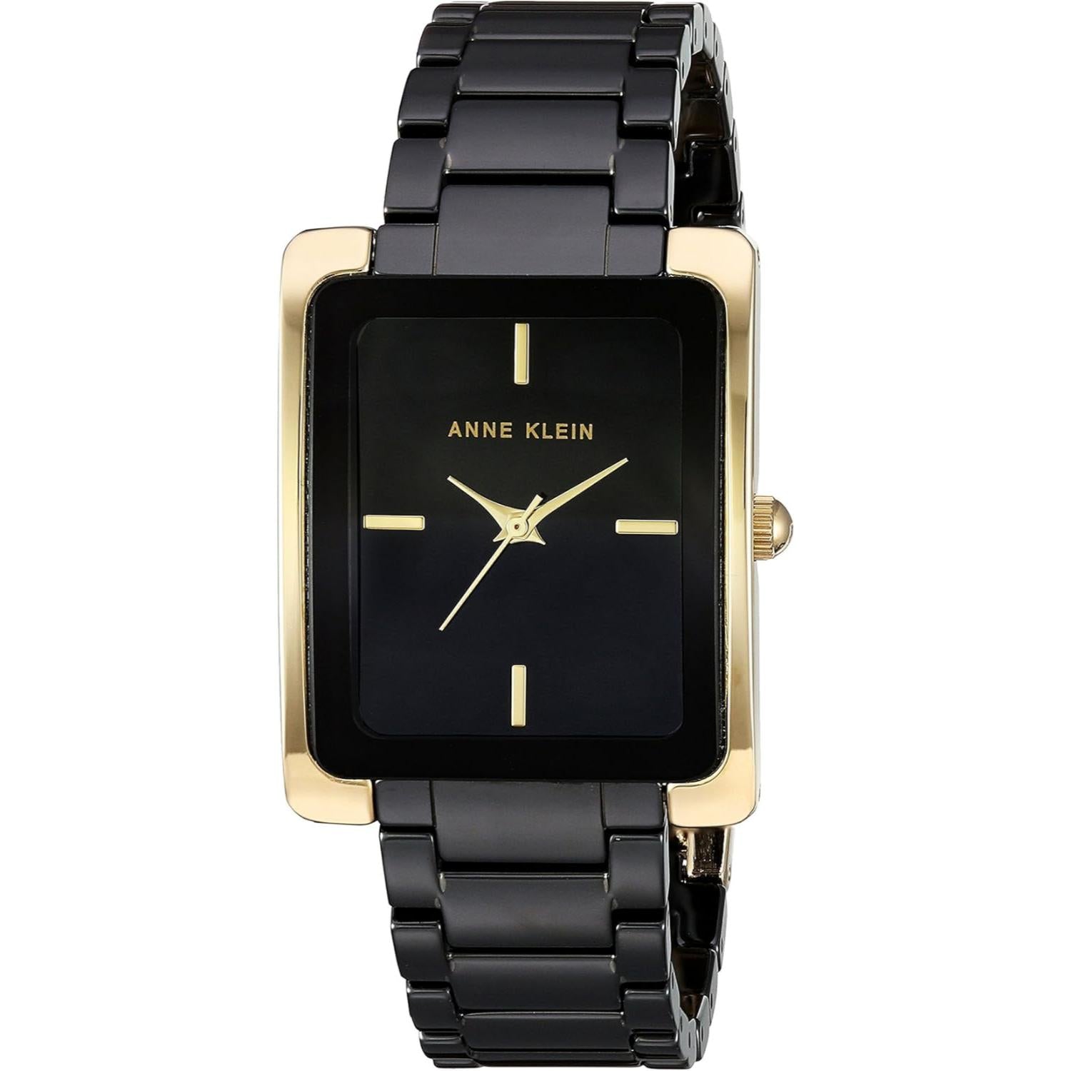 reloj Anne Klein AK/2952BKGB con caja rectangular en tono dorado, esfera negra minimalista y brazalete metálico negro visto de frente