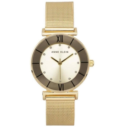 Anne Klein AK-3780CHGBST with round dial, gold-tone case, Roman numeral markers, crystal accents, side crown, and gold-tone mesh bracelet.