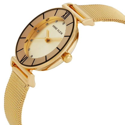 Anne Klein AK-3780CHGBST with angled round dial, gold-tone case, Roman numeral markers, crystal accents, side crown, and gold-tone mesh bracelet.