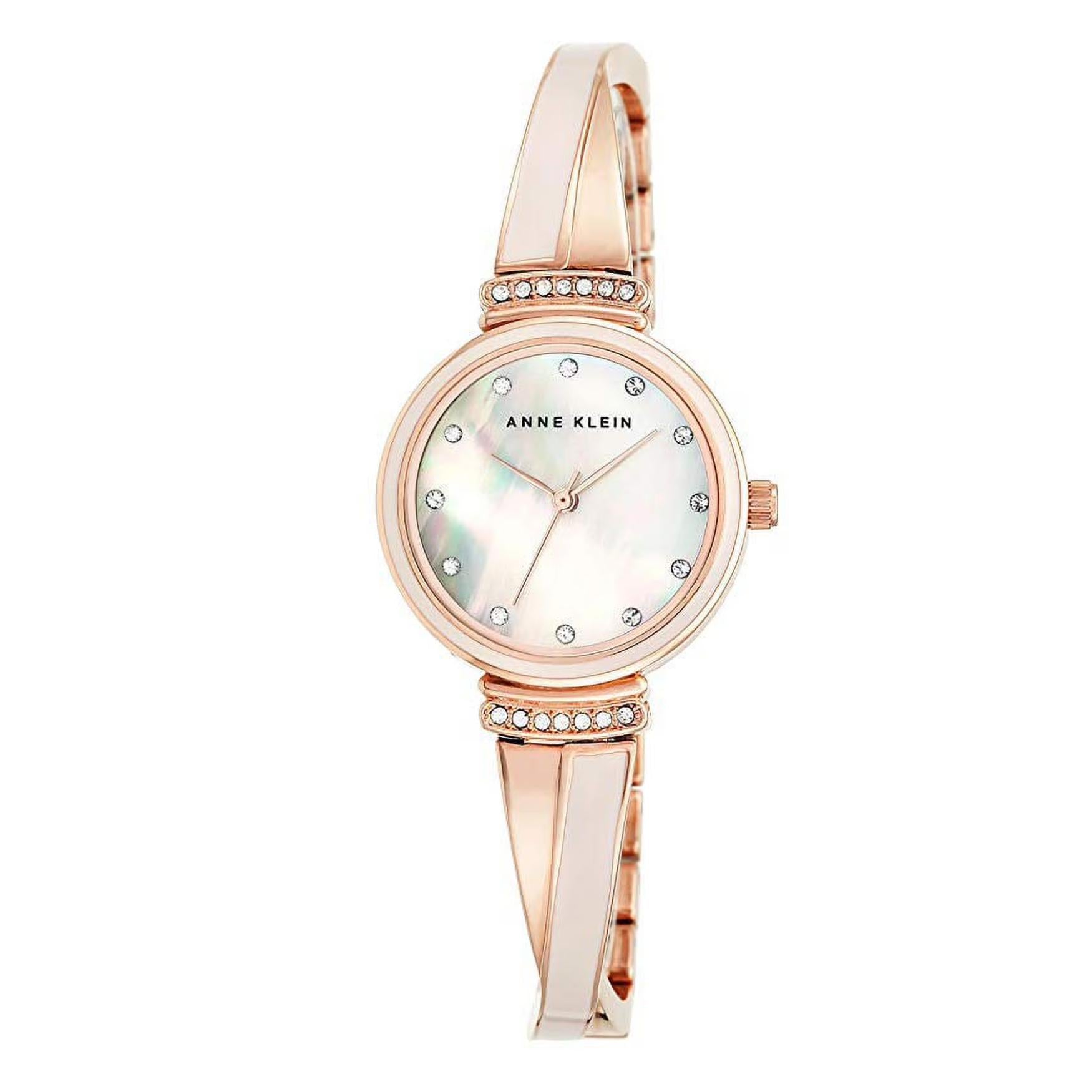 Anne Klein AK/2216BLRG with white mother-of-pearl dial, crystal hour markers, rose gold-tone case, and polished bangle bracelet with crystal accents.