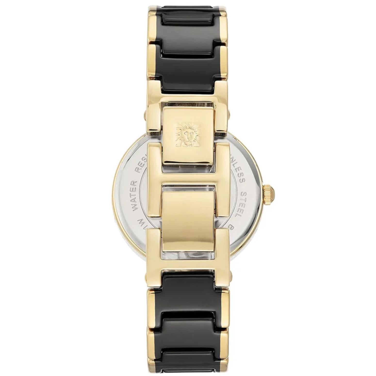 Anne Klein AK/3844BKGB women’s dress watch with stainless steel caseback, black bracelet links and gold-tone jewelry clasp detail.