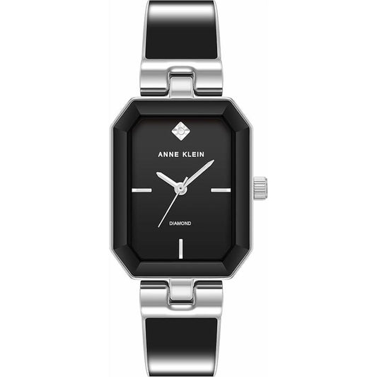Anne Klein AK/4163BKSV with black dial, diamond accent marker, rectangular silver-tone case, and polished black and silver-tone bangle bracelet.