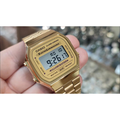 Casio A168WG-9UR vintage digital watch with gold tone case and stainless steel bracelet shown in close up held in hand with retro design