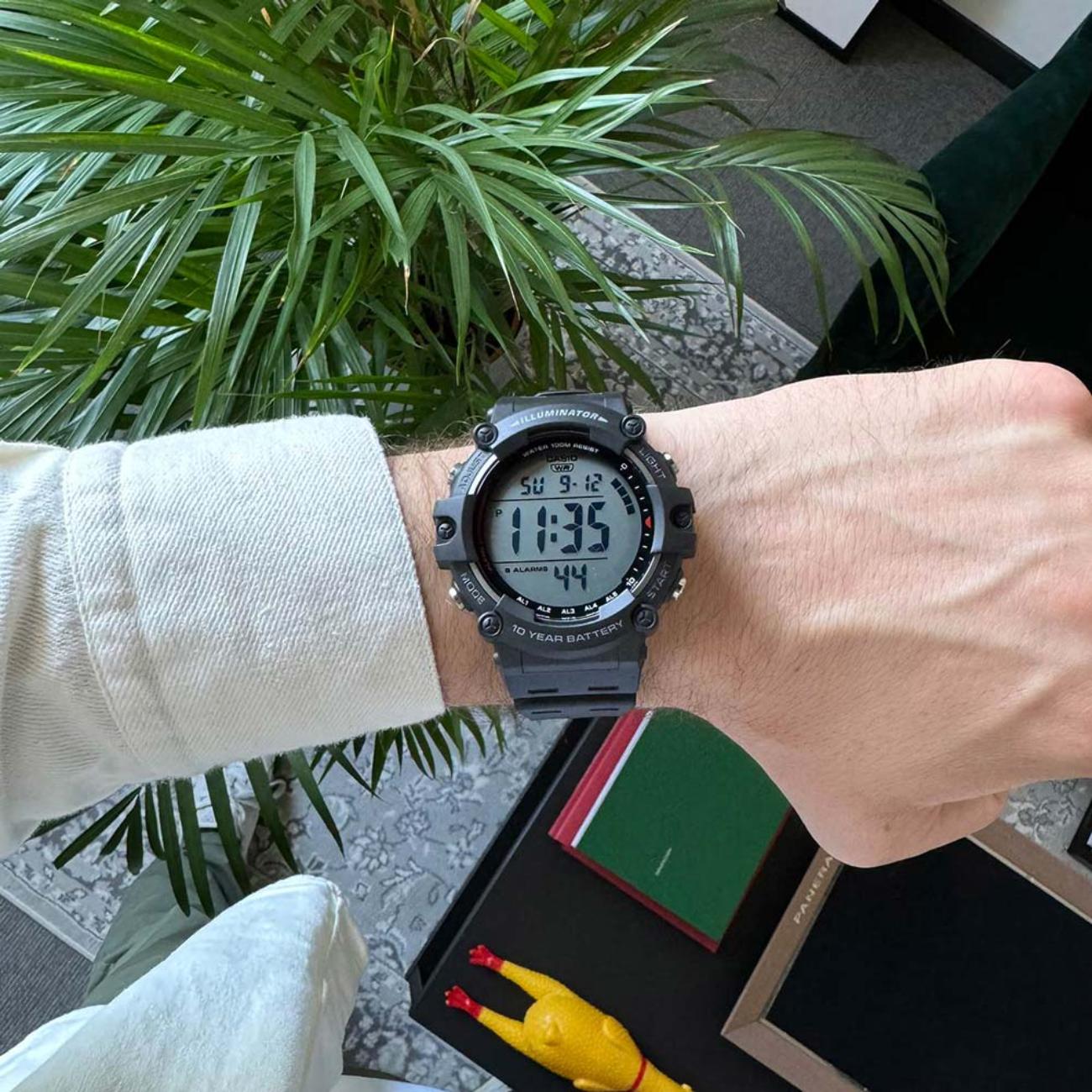 Casio AE1500WH-1AV digital watch worn on the wrist with large LCD display, black resin case and black resin strap.