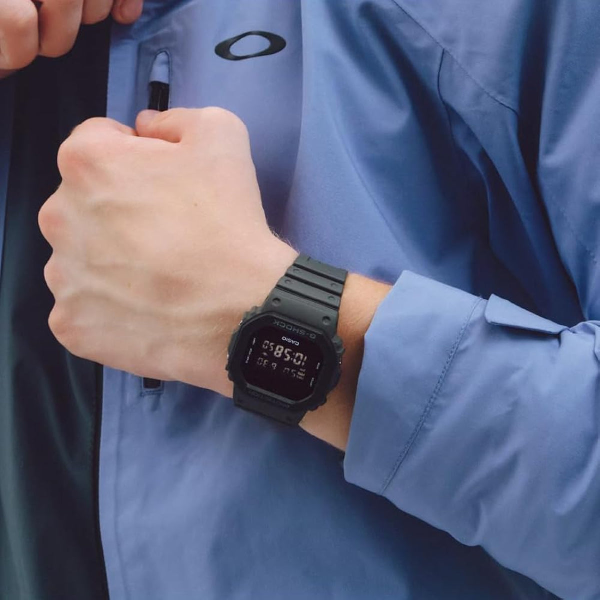 Casio G-Shock DW-5610UU-8DR men’s digital watch with a dark gray resin case and strap, square negative digital display, and tonal G-Shock bezel worn on the wrist.