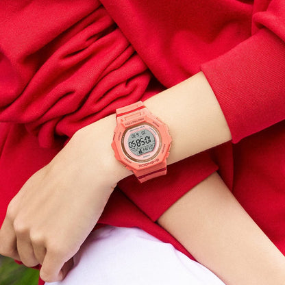 Casio G-Shock G-Squad GMD-B300SC-4DR women’s digital sport watch with a coral-tone case and strap, round digital display, and matching coral design worn on the wrist.