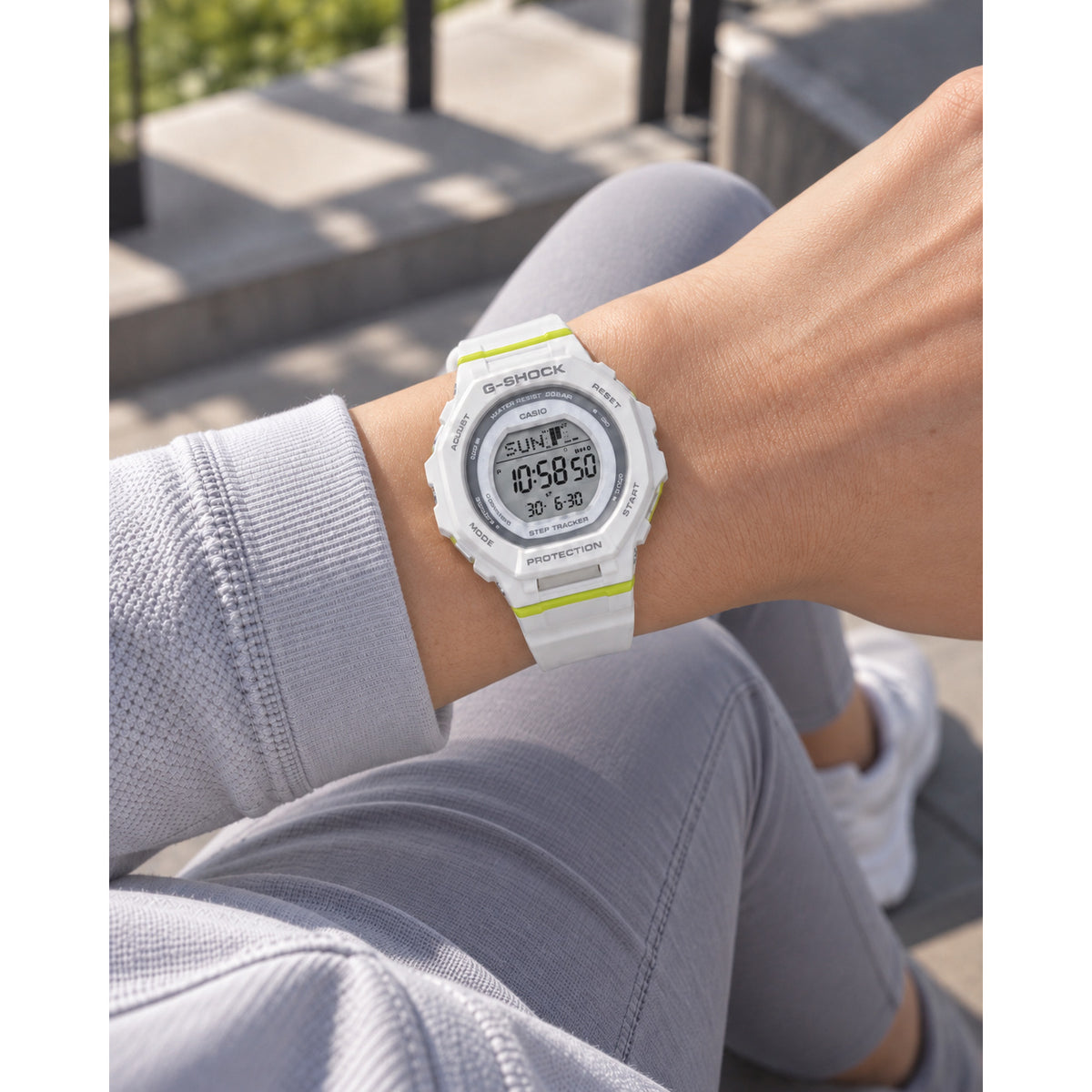 Casio G-Shock G-Squad GMD-B300SC-7 worn on the wrist with digital LCD display, white resin case and strap, gray bezel details, and lime green accents.
