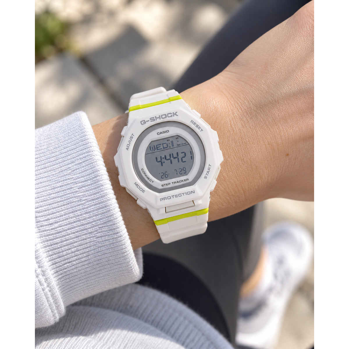 Casio G-Shock G-Squad GMD-B300SC-7DR women’s digital sport watch with a white case and strap, round digital display, and lime accents worn on the wrist.
