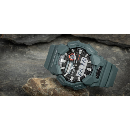 Casio G-Shock GA-010-2A with a black analog-digital dial, bold silver-tone hour markers, red accents, and a dark green resin case and strap.