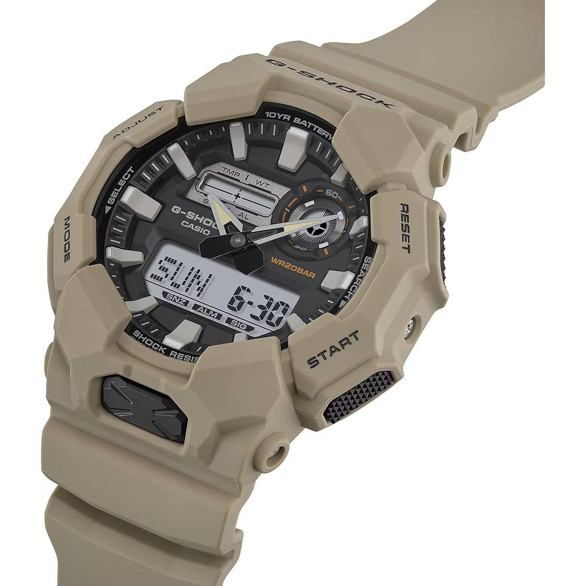 Casio G-Shock GA-010-5A watch with a black ana-digi dial, dual digital displays, orange accents, rugged beige case, and matching beige resin strap.