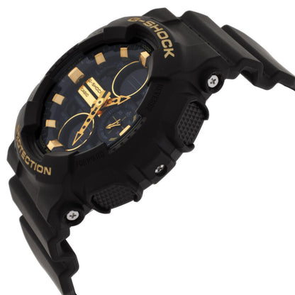 Casio G-Shock GA-100GB-1A watch in side profile with a black protective case, gold-tone dial accents, textured side buttons, and matching black resin strap.