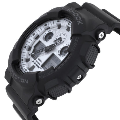 Casio G-Shock GA-100WD-1A from a side angle with a white analog-digital dial, black resin case, textured push buttons, and exposed metal accents.