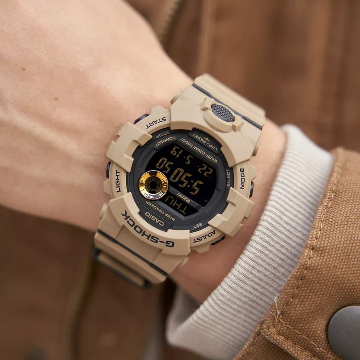 Casio G-Shock G-Squad GBD-800UC-5 digital sport watch worn on the wrist showing the tan resin strap and dark digital dial.