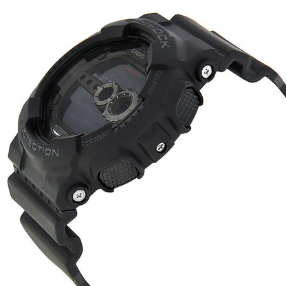 Casio G-Shock GD-100-1B watch in side profile with a rugged black resin case, textured side buttons, exposed screws, and black digital display.