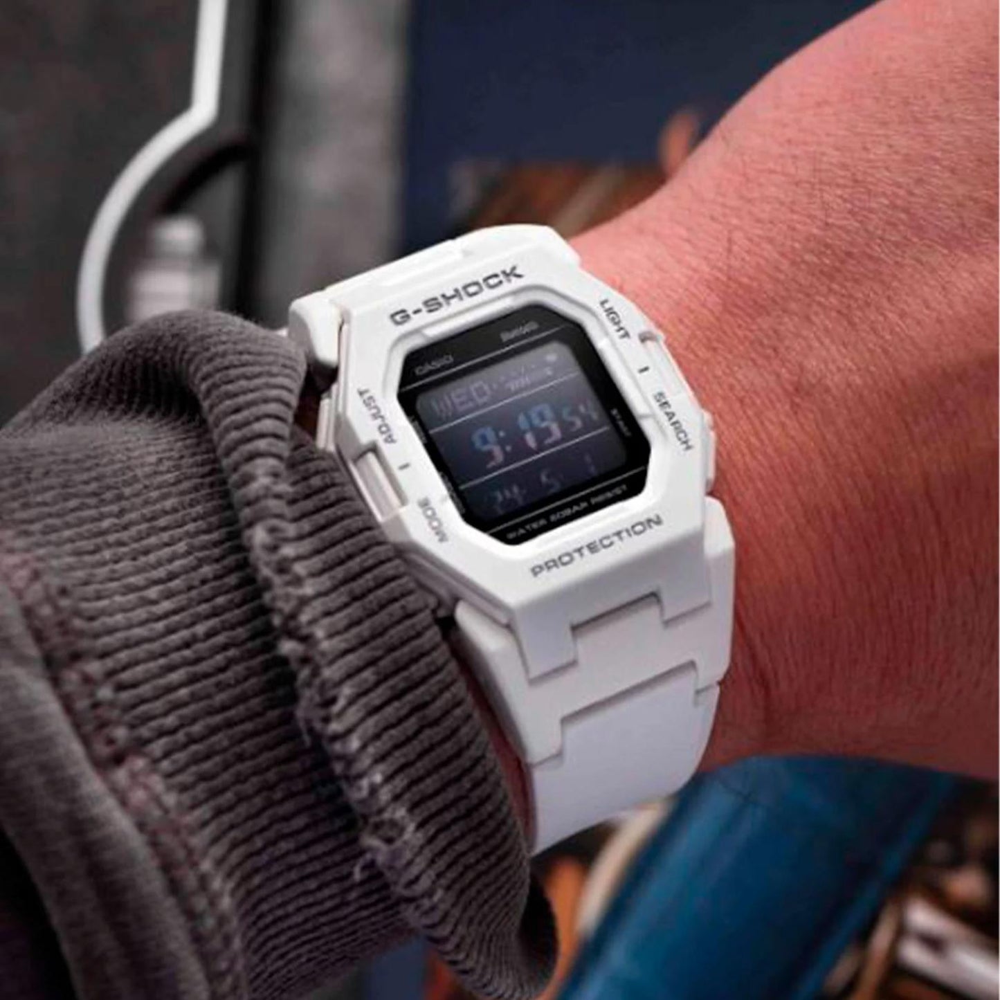 Casio G-Shock GD-B500-7 digital sport watch worn on the wrist, featuring a white resin case and strap, black digital display, and compact shock-resistant design.