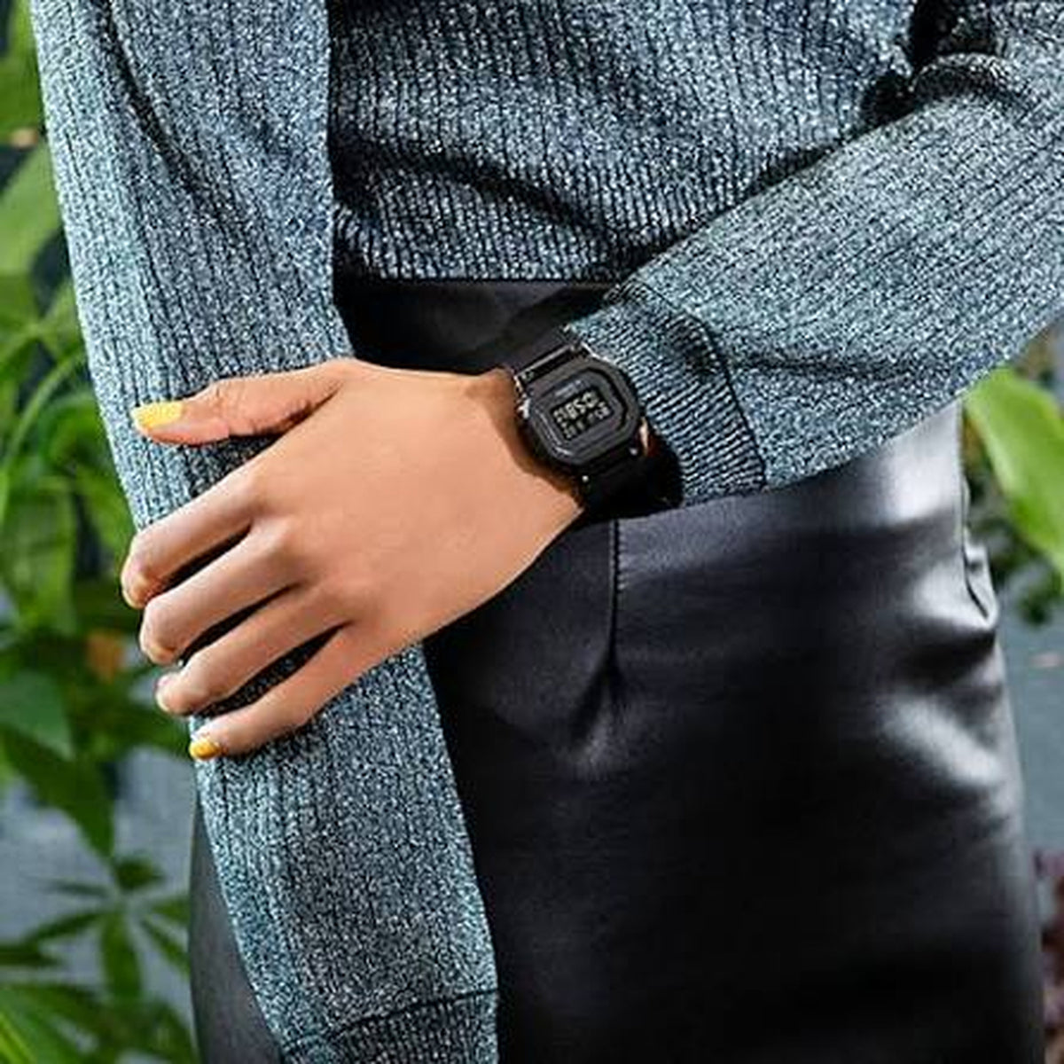 Casio G-Shock GM-S5600SB-1 women's digital watch lifestyle shot worn on a wrist with a knitted sweater and leather skirt