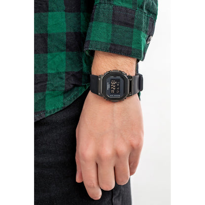 Casio G-Shock GM-S5600SB-1 women's digital watch worn on a wrist with a green plaid flannel shirt