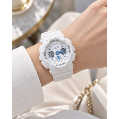 Casio G-Shock GMA-S120SA-7A2DR women's sport watch worn on wrist, featuring a white resin case and strap, white dial, and bright blue hands.