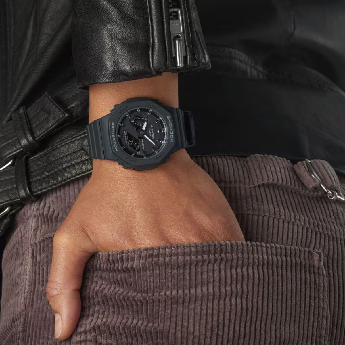 Casio G-Shock GMA-S2100-1A with a black octagonal case, black dial, matching black resin strap, and rose gold-tone hands and markers worn on the wrist.