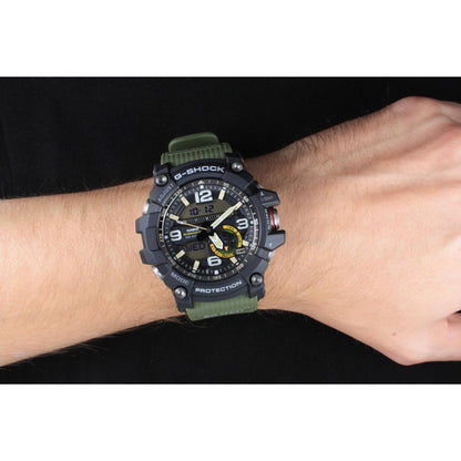 Casio G-Shock Mudmaster GG-1000-1A3 worn on the wrist, featuring a rugged black analog-digital dial, shock-resistant case, and green resin strap.