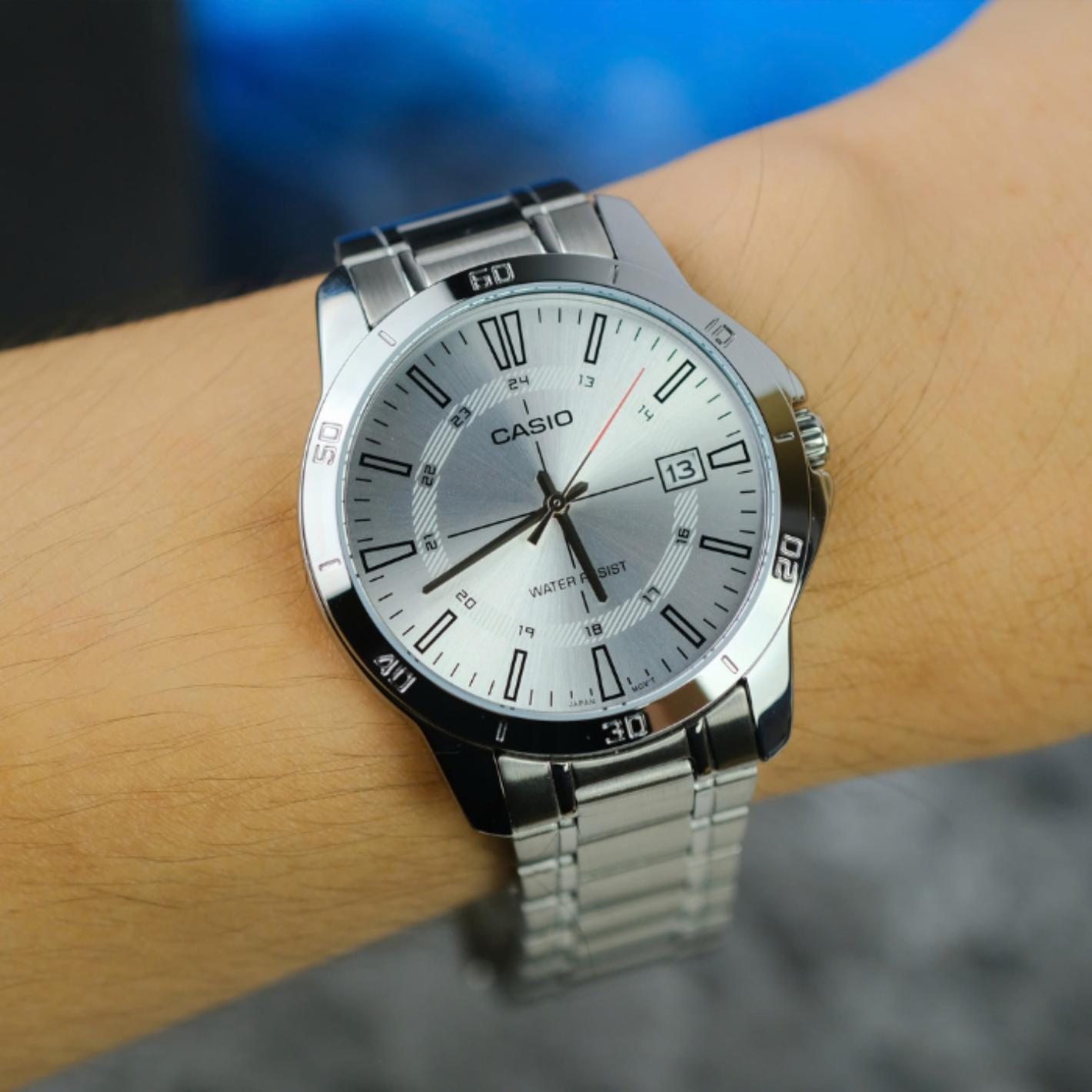 Casio MTP-V004D-7CUDF quartz watch worn on the wrist with white dial, date display, stainless steel case and stainless steel bracelet.