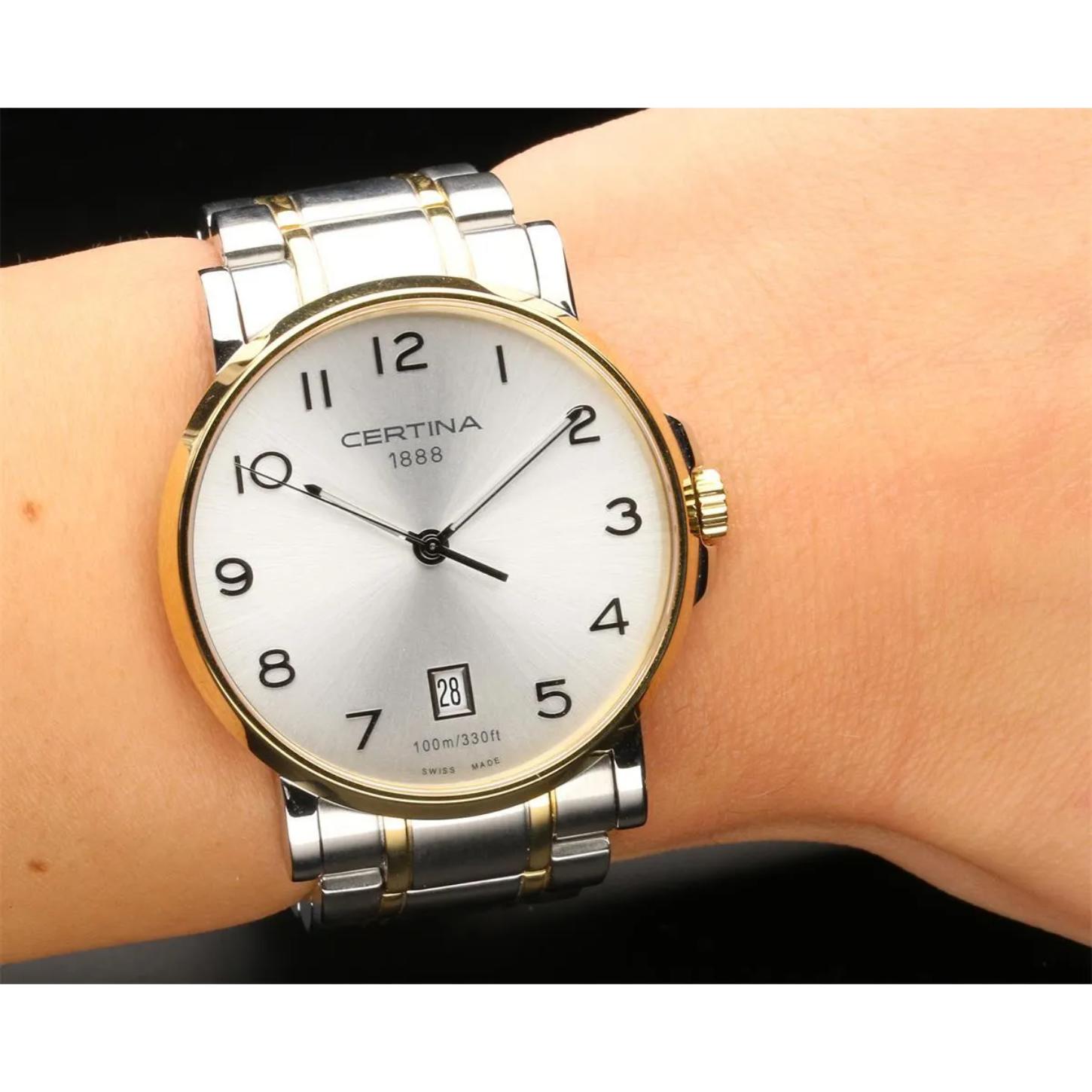 Certina C017.410.22.032.00 mens dress watch with silver dial, gold tone bezel and two tone stainless steel bracelet worn on wrist with classic style