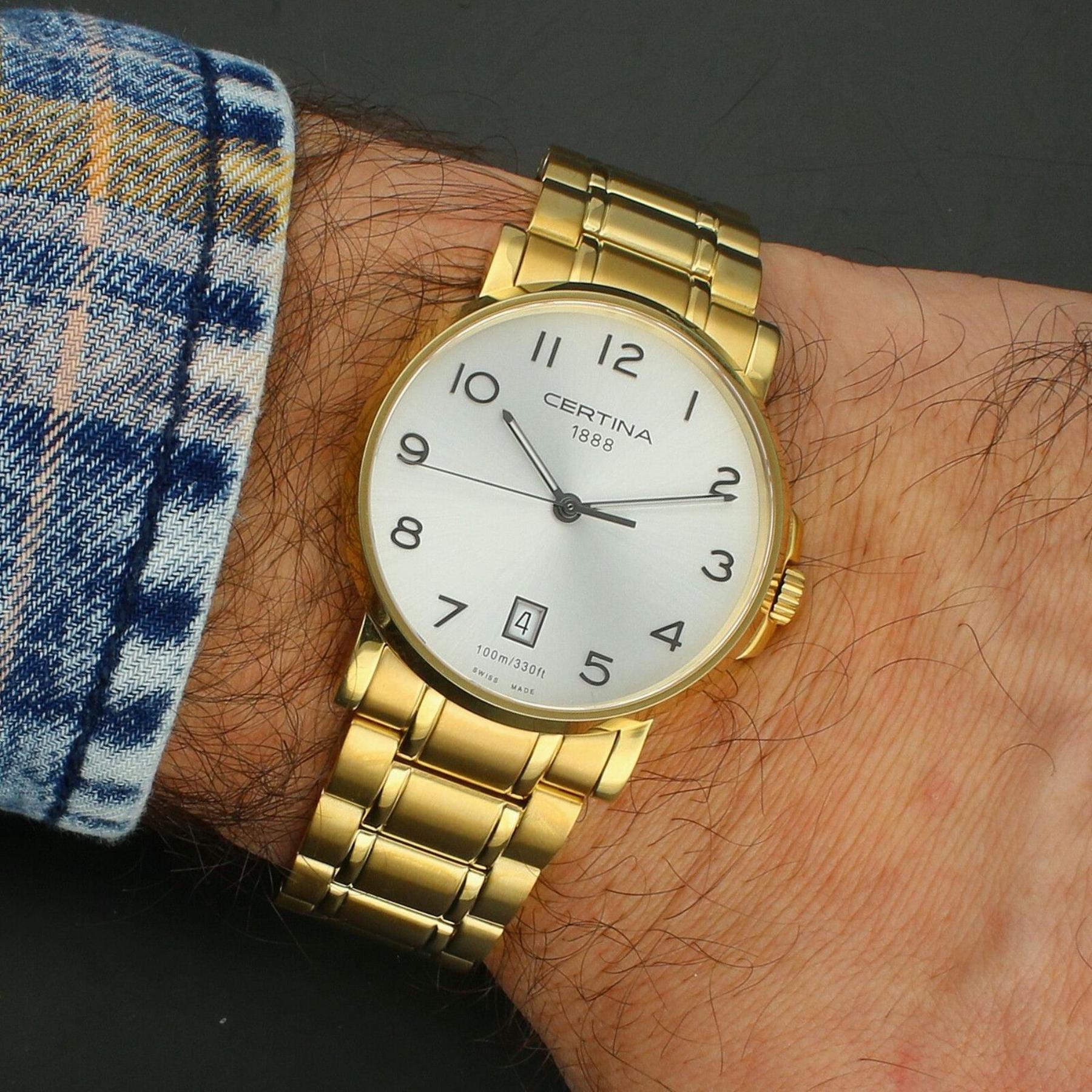 Certina C017.410.33.032.00 quartz watch worn on the wrist with white dial, Arabic numerals, gold-tone stainless steel case and bracelet.