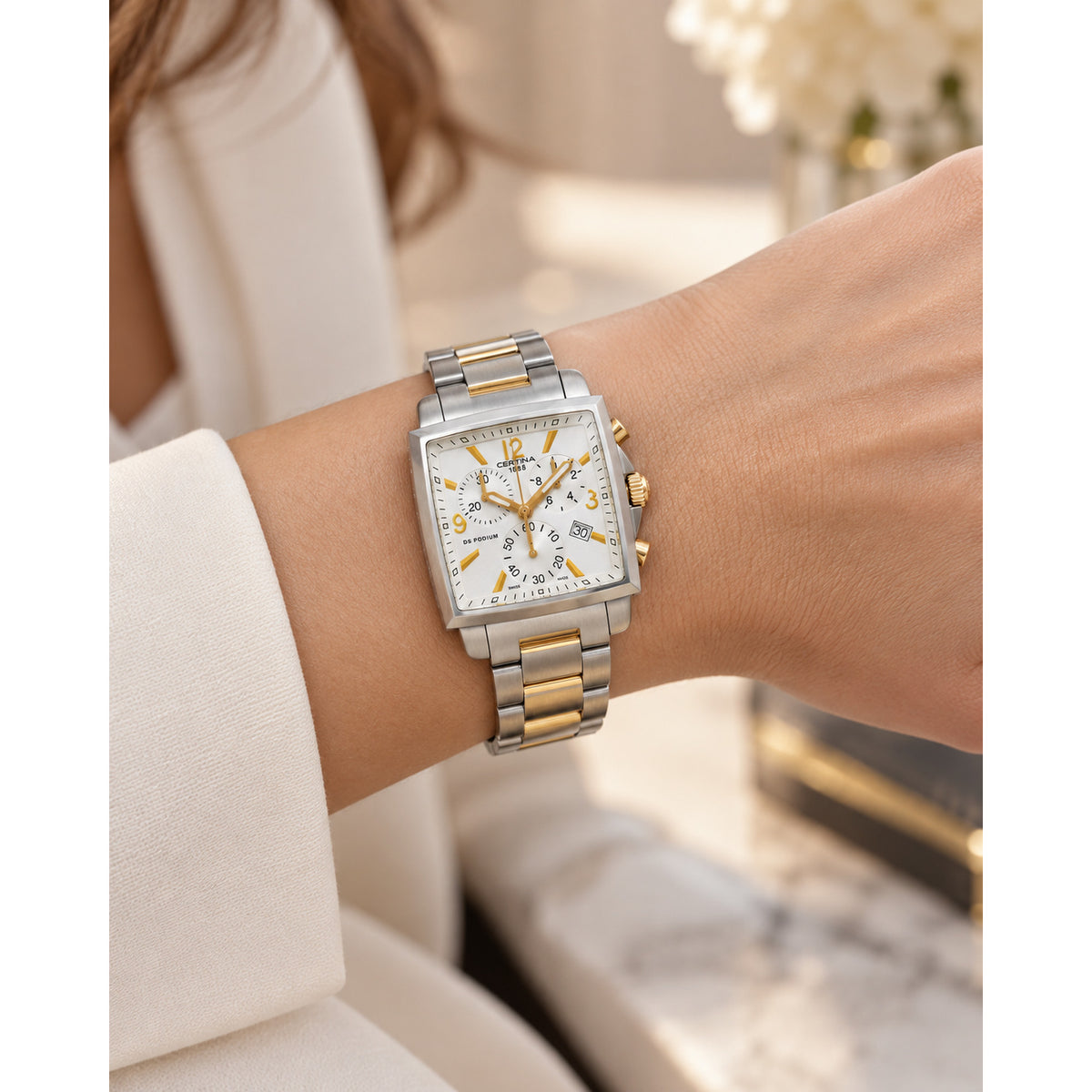 Certina DS Podium women's quartz chronograph watch featuring a rectangular silver dial and two-tone stainless steel bracelet worn on a wrist