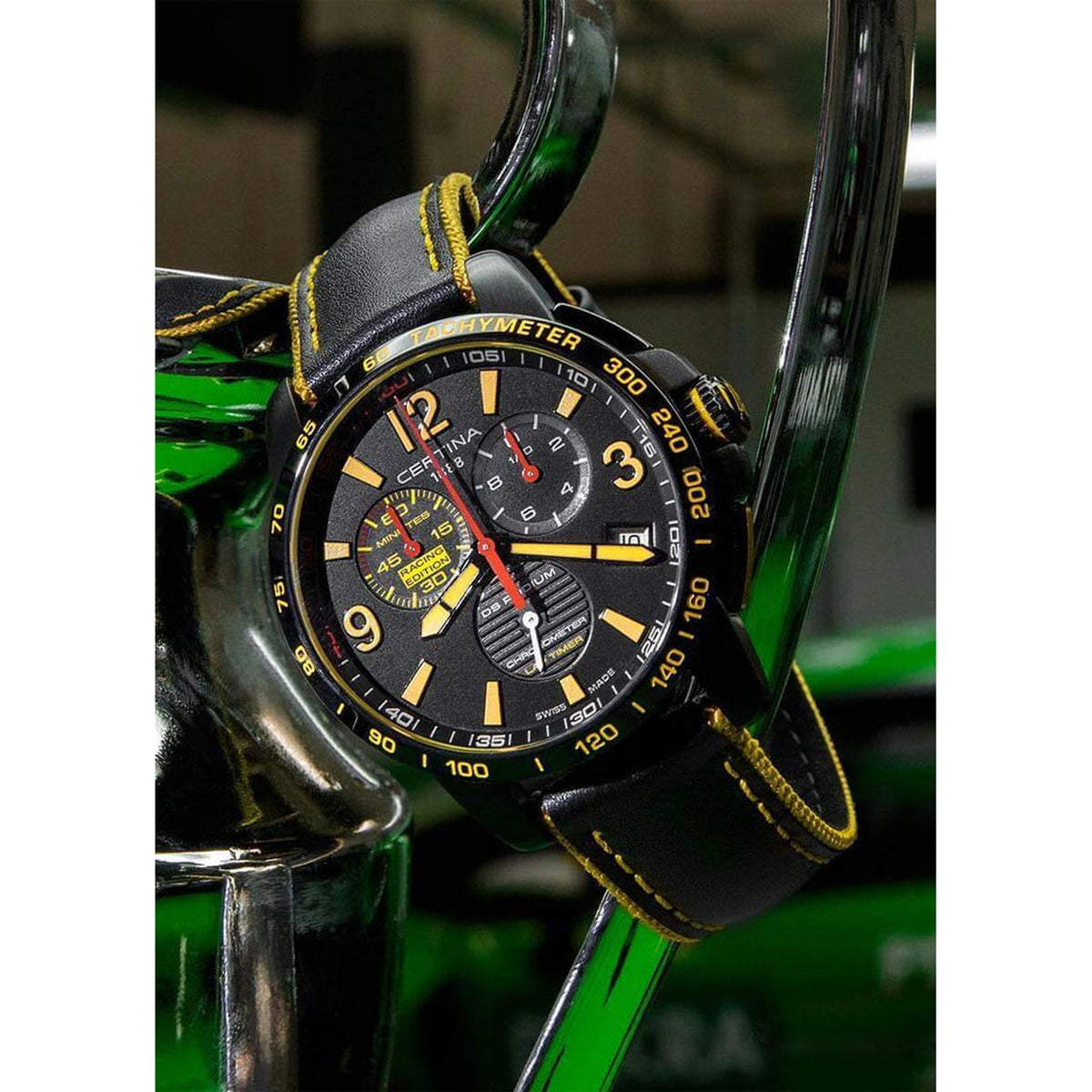 Certina DS Podium quartz chronograph watch featuring a black dial with yellow accents and yellow-stitched black leather strap
