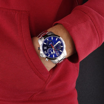 Certina DS Podium C034.654.11.047.00 with a blue chronograph dial, silver-tone tachymeter bezel, and matching stainless steel bracelet worn on the wrist.