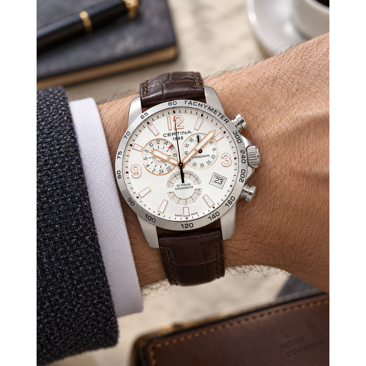Certina DS Podium C034.654.16.037.01 chronograph watch worn on wrist with silver dial, rose gold-tone markers, and brown leather strap