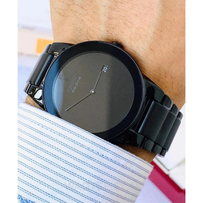 Citizen AU1065-58E mens watch on wrist with black minimalist dial, black stainless steel bracelet and sleek modern dress style