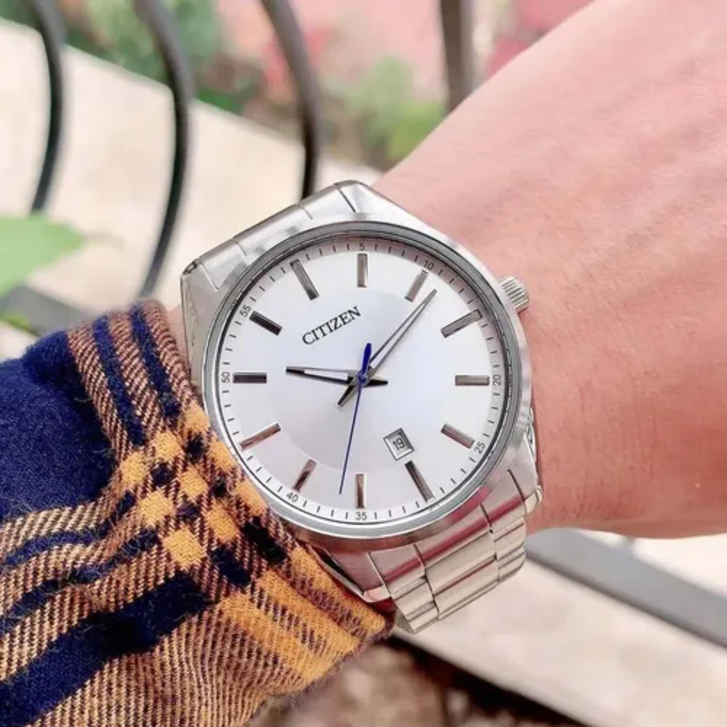 Citizen BI1030-53A mens watch with silver dial and stainless steel bracelet worn on wrist in everyday casual style