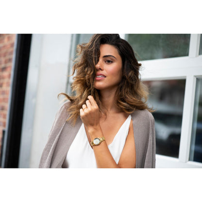 Citizen EM0732-51P womens dress watch with champagne dial, diamond markers and gold tone stainless steel bracelet worn on wrist with elegant style