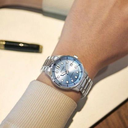 Citizen NJ0191-83L men's automatic watch with a light blue dial and stainless steel bracelet worn on the wrist.