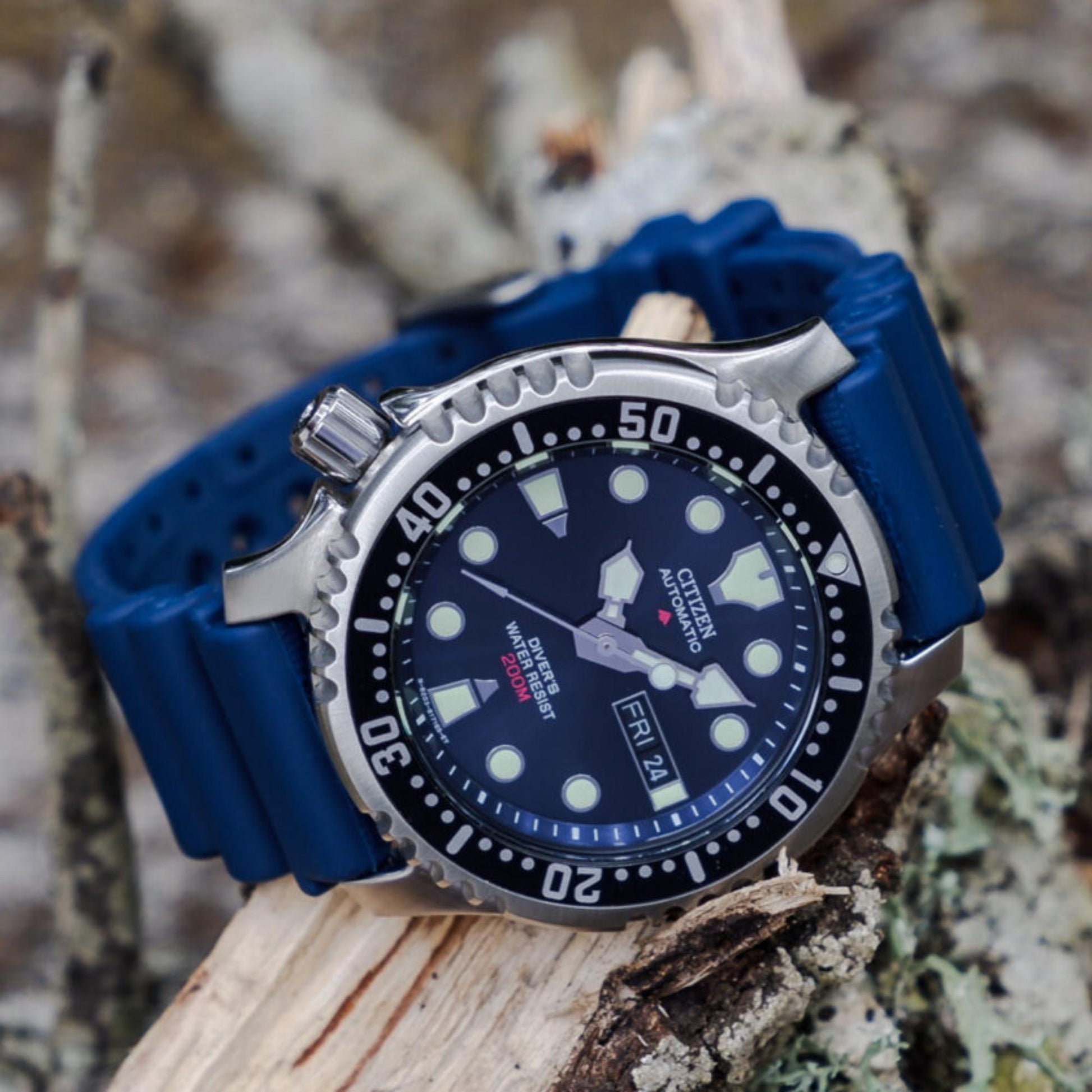 Citizen Promaster NY0040-17L with blue dial, black rotating bezel with white scale, and crown positioned on the left in a stainless steel case with blue rubber strap.