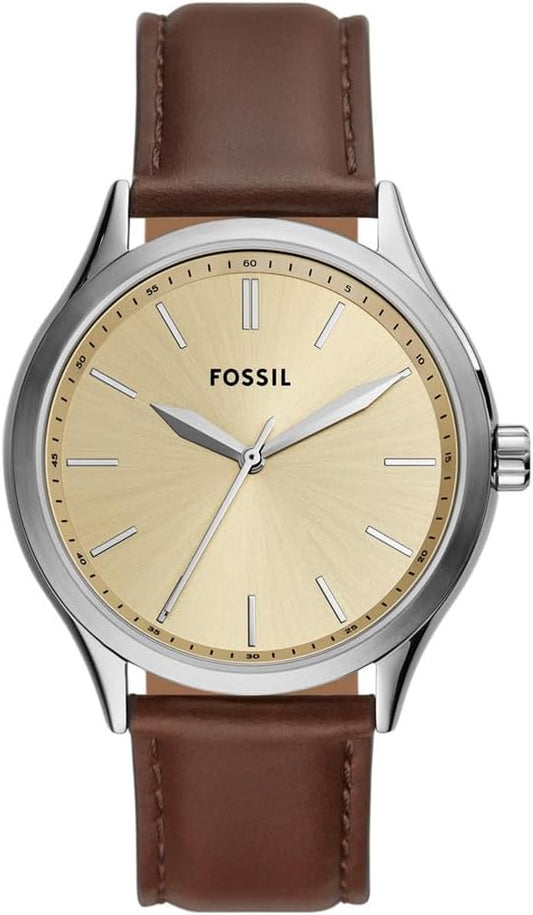 Reloj Fossil analógico con esfera dorada y correa de cuero marrón mostrado en vista frontal.