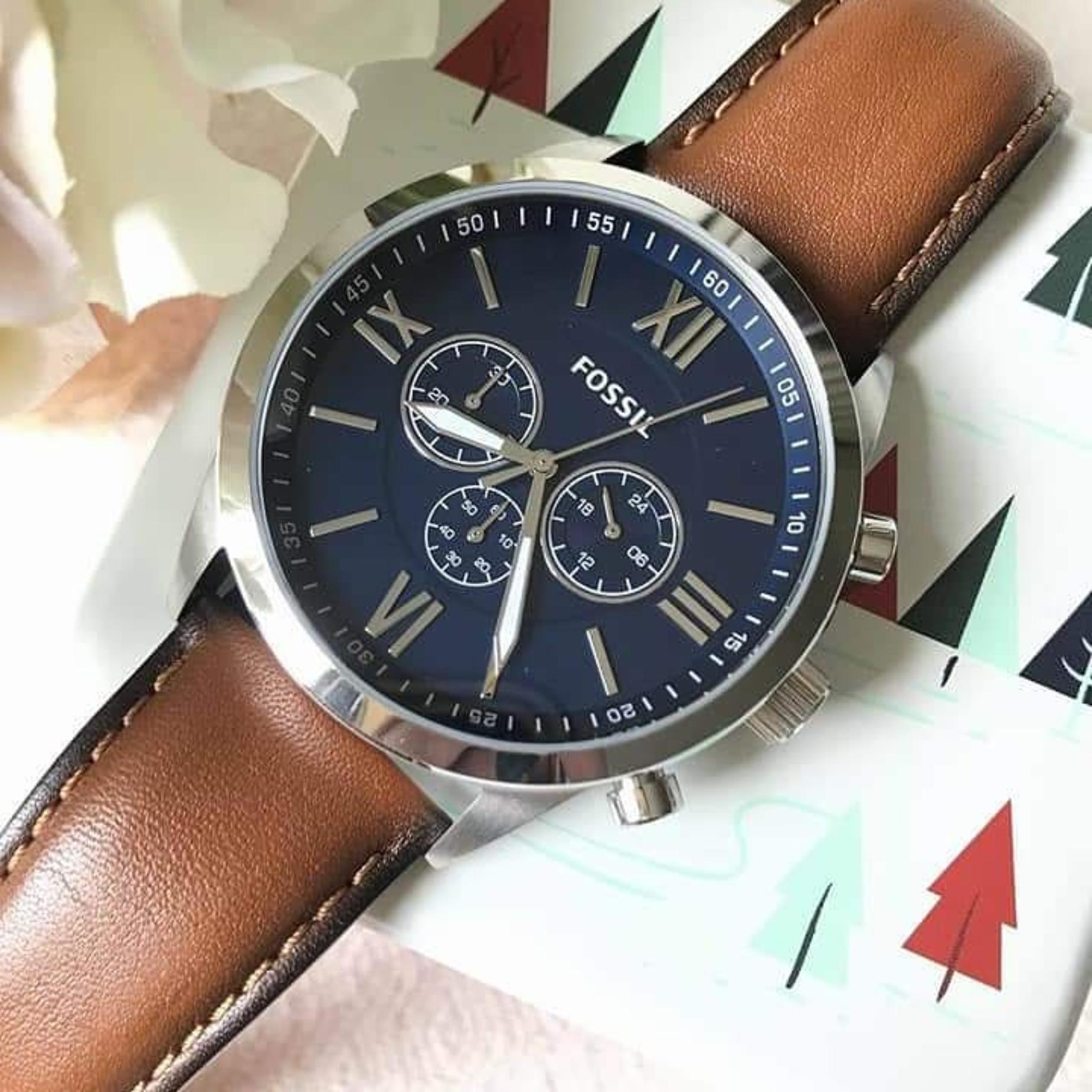 Fossil BQ2125IE chronograph watch with blue dial, silver-tone case, Roman numeral hour markers, and brown leather strap shown in a close-up angled view