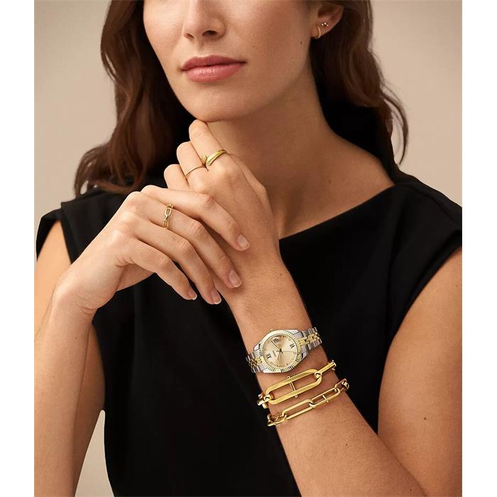 Fossil ES4949 worn on the wrist with gold dial, fluted bezel, stainless steel case and two-tone stainless steel bracelet.