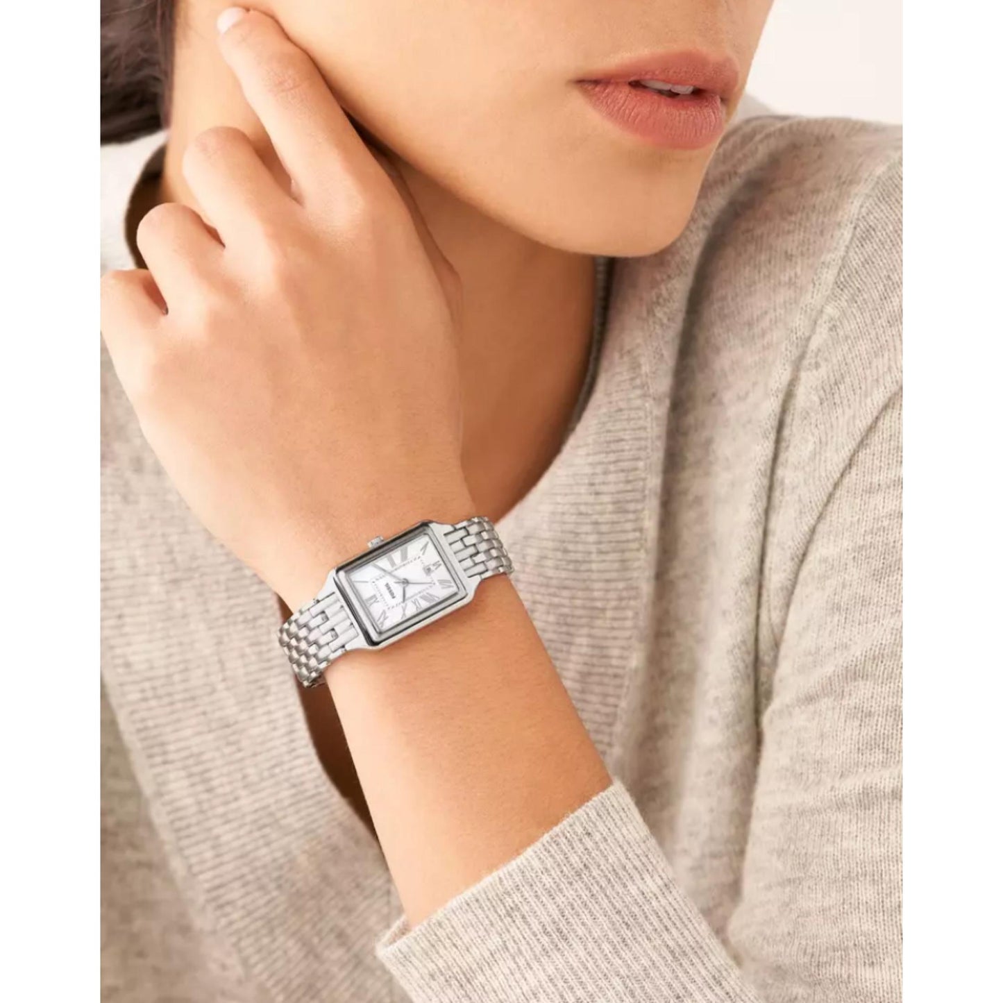 Fossil ES5306 womens rectangular watch with mother of pearl dial and stainless steel bracelet worn on wrist in elegant everyday style