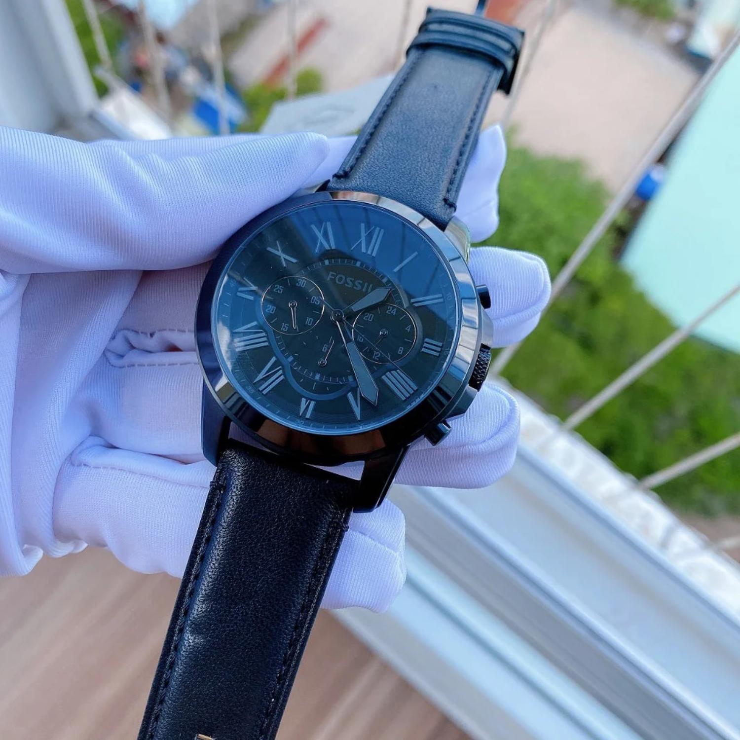 Fossil FS5151 mens chronograph watch with black dial and Roman numerals held in hand showing leather strap and subdial details