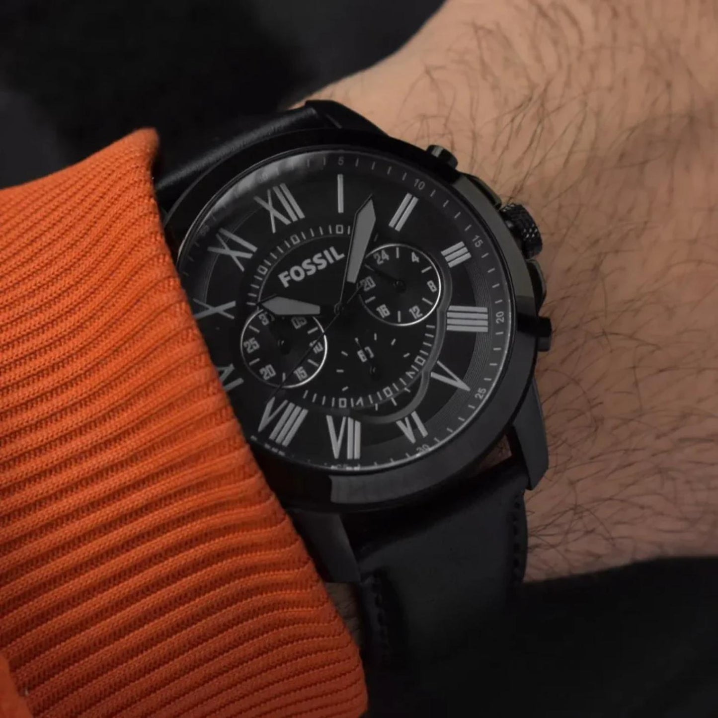 Fossil FS5151 mens chronograph watch with black dial and Roman numerals worn on wrist with black leather strap in casual style